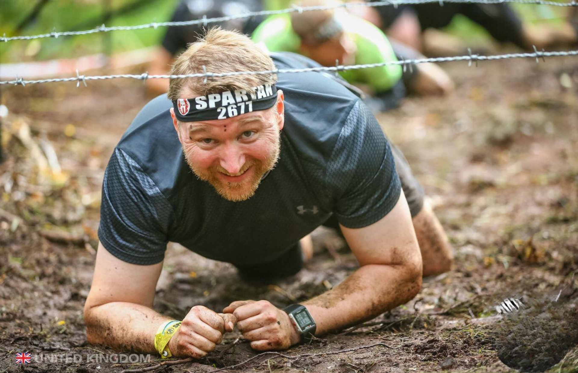 Rob Ede, personal trainer in Lightwater, at Spartan Race performing barbwire crawl