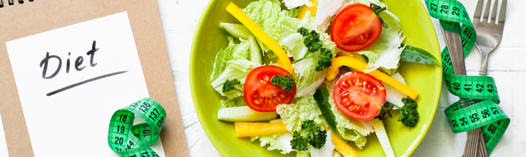 A plate of healthy foods including avocado, salmon, and vegetables