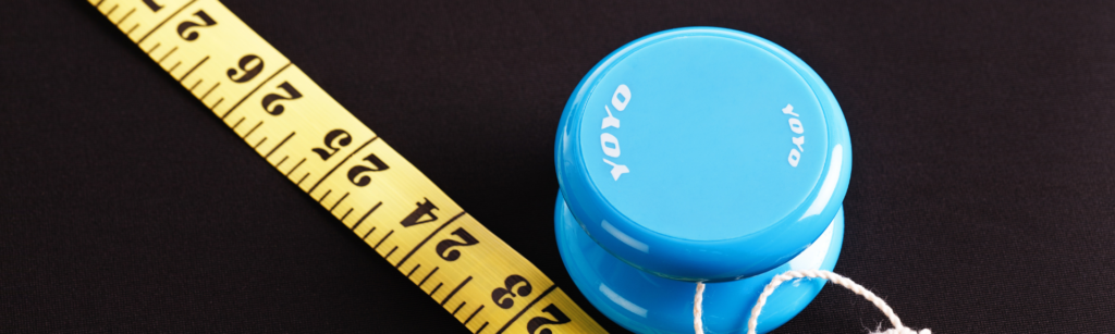 Blue yo-yo with measuring tape representing yo-yo dieting